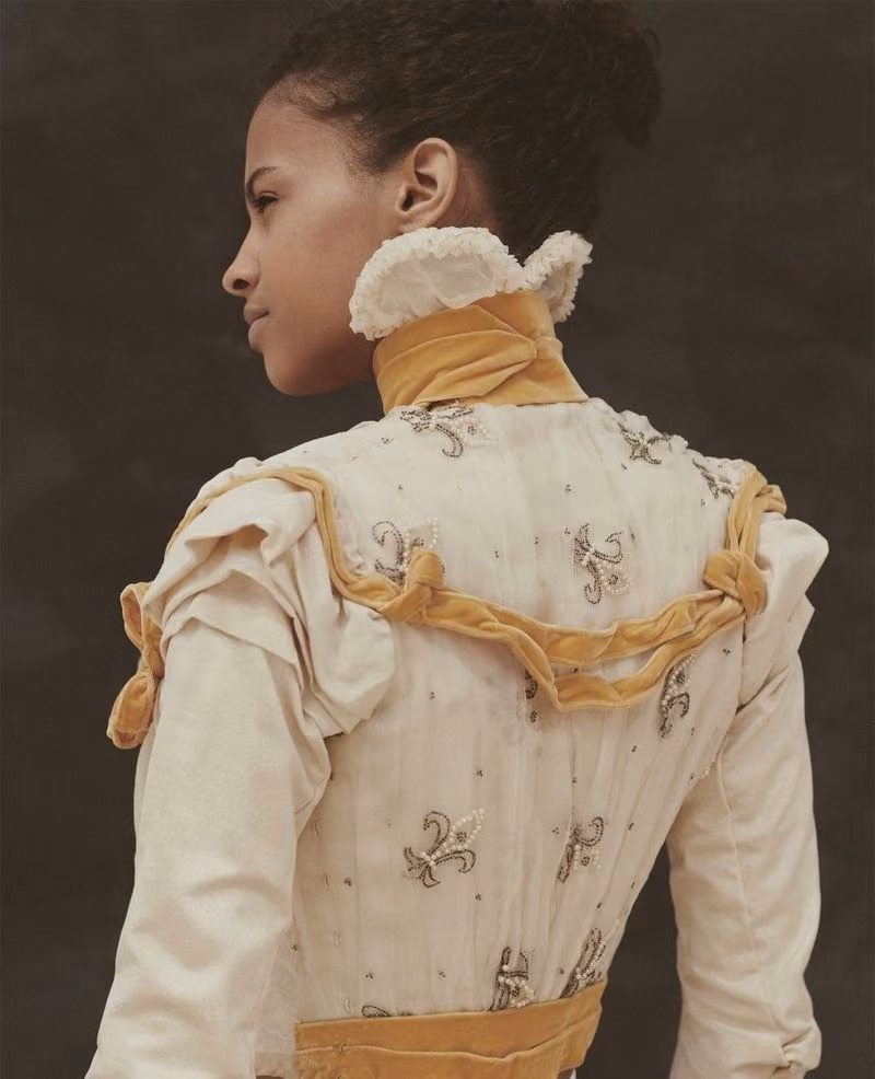 Off-white bodice with orange trim, back view — Augusta Lundin