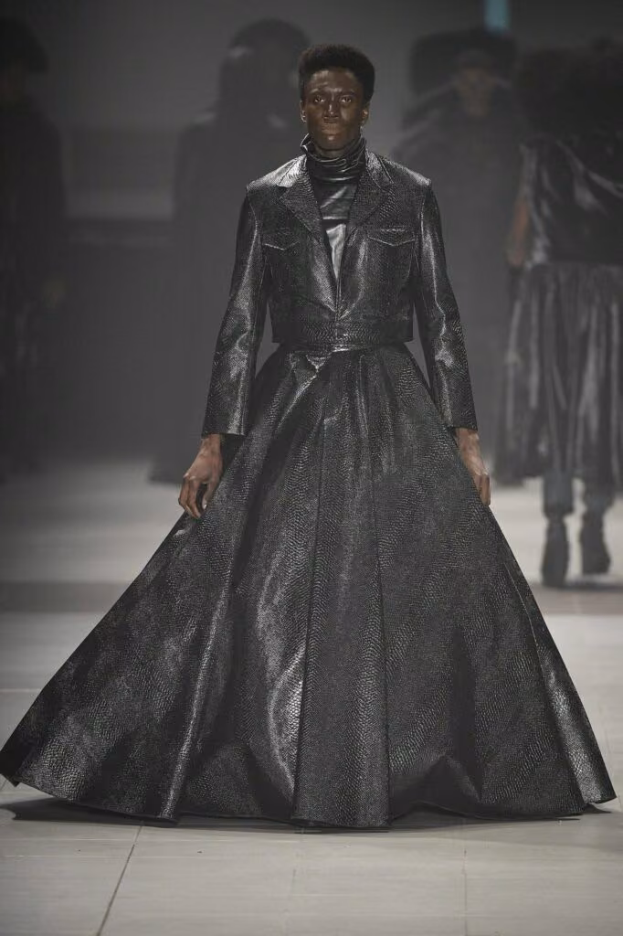 Black tailored upper garment with voluminous floor-length skirt — João Pimenta