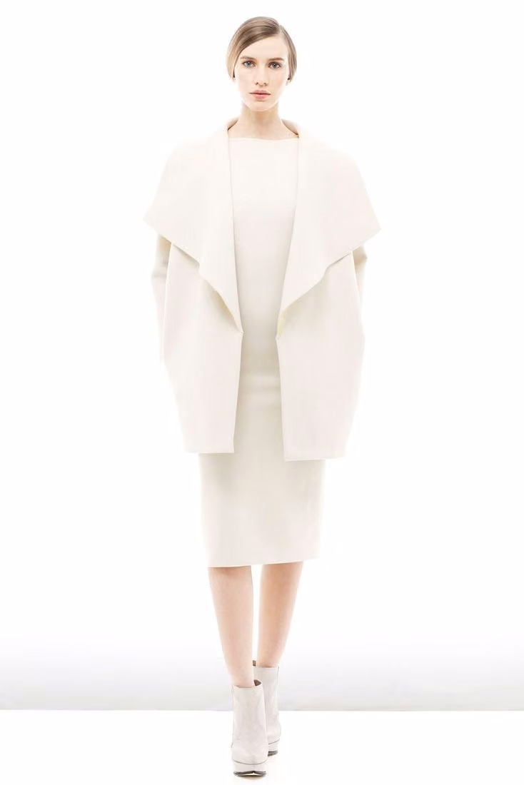 White sculptural cape-like jacket and pencil skirt — Look 1 — Maria Grachvogel