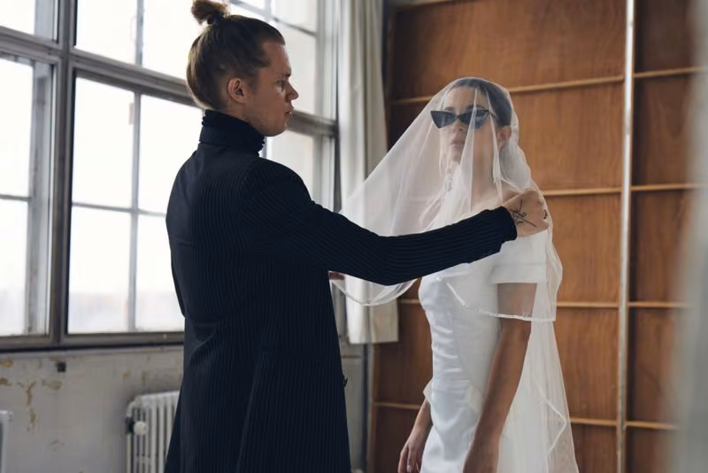 White wedding dress with dramatic folded shoulder detail — Soeren Le Schmidt
