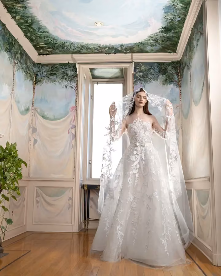 Long-sleeved bridal gown with an expansive skirt — Reem Acra, Spring 2025
