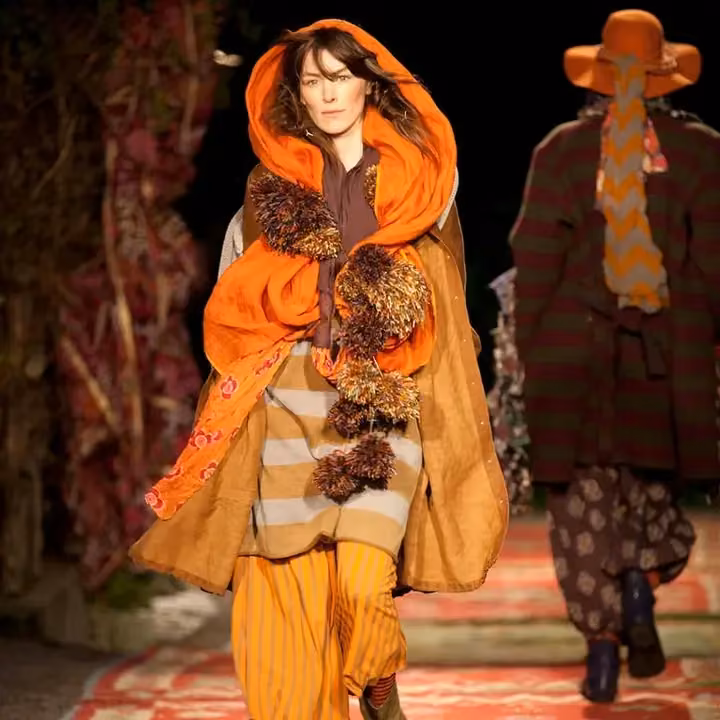 Orange hooded coat with striped trousers — Gudrun Sjödén, Shown 2011