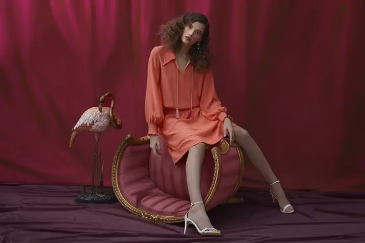 Coral draped dress with asymmetric flowing hem — Frank Remme, Date not documented