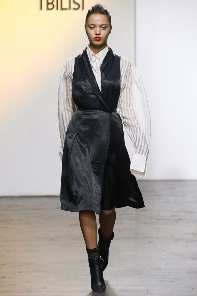 Black wrap dress over a striped shirt — George Pantsulaia, Tbilisi Spring 2017