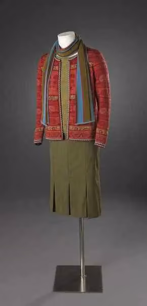 Patterned knit cardigan, striped scarf and pleated skirt — Solveig Hisdal, 2007 (source caption)