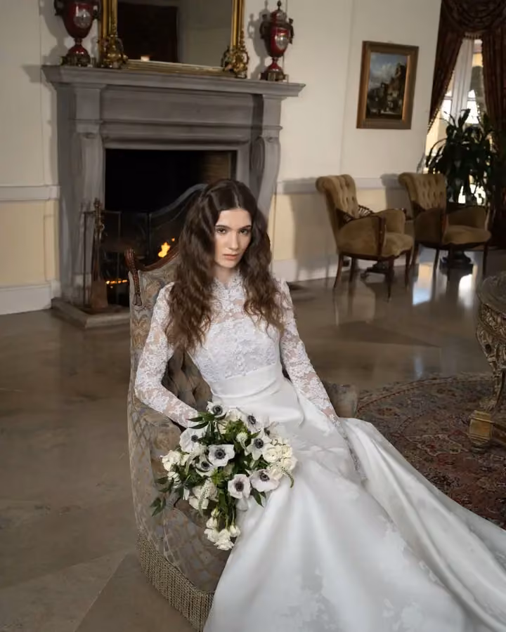 White bridal dress with long lace sleeves — Reem Acra, Spring 2025