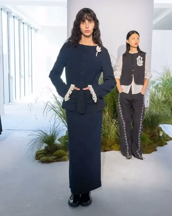Black long-skirt ensemble with pale waist detail — Kinyan Lam, Summer 2026