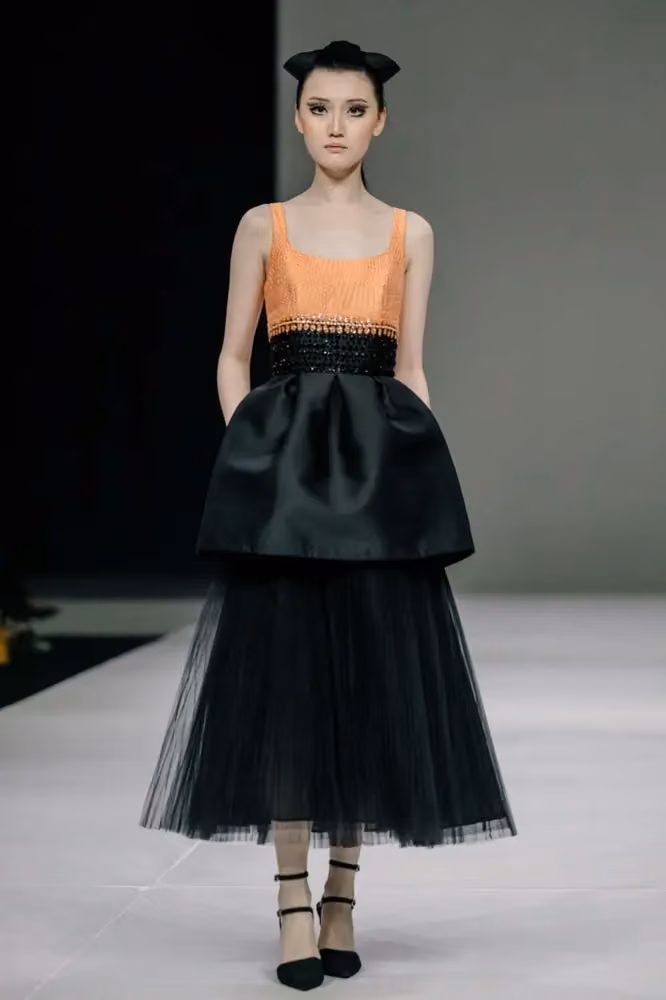Orange bodice with a tiered black skirt — Sebastian Gunawan & Cristina Panarese, 2024–2025