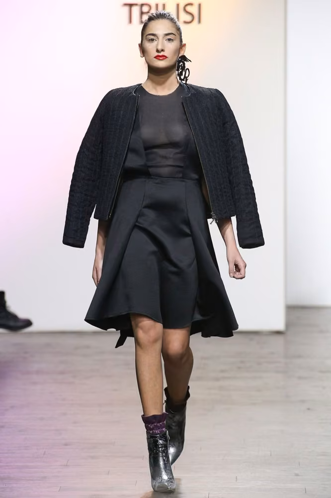 Black jacket over a sheer top and flared skirt — George Pantsulaia, Tbilisi Spring 2017