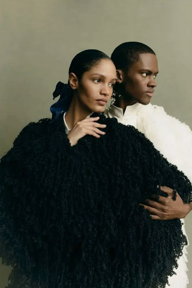 Textured black cape, alongside a cream ensemble — Adeju Thompson, Fall/Winter 2024