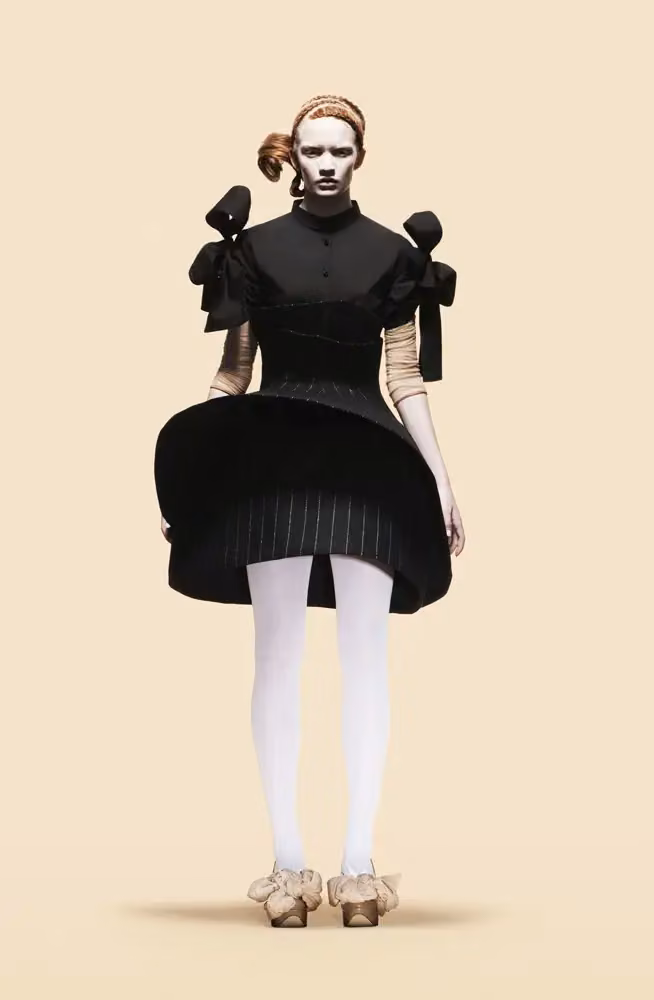 Black circular miniskirt and bow-shoulder top — Astrid Olsson, Autumn/Winter 2010