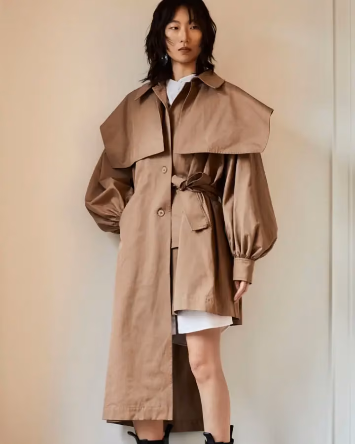 Beige belted cape trench coat — Golnar Ahmadian, Date not documented
