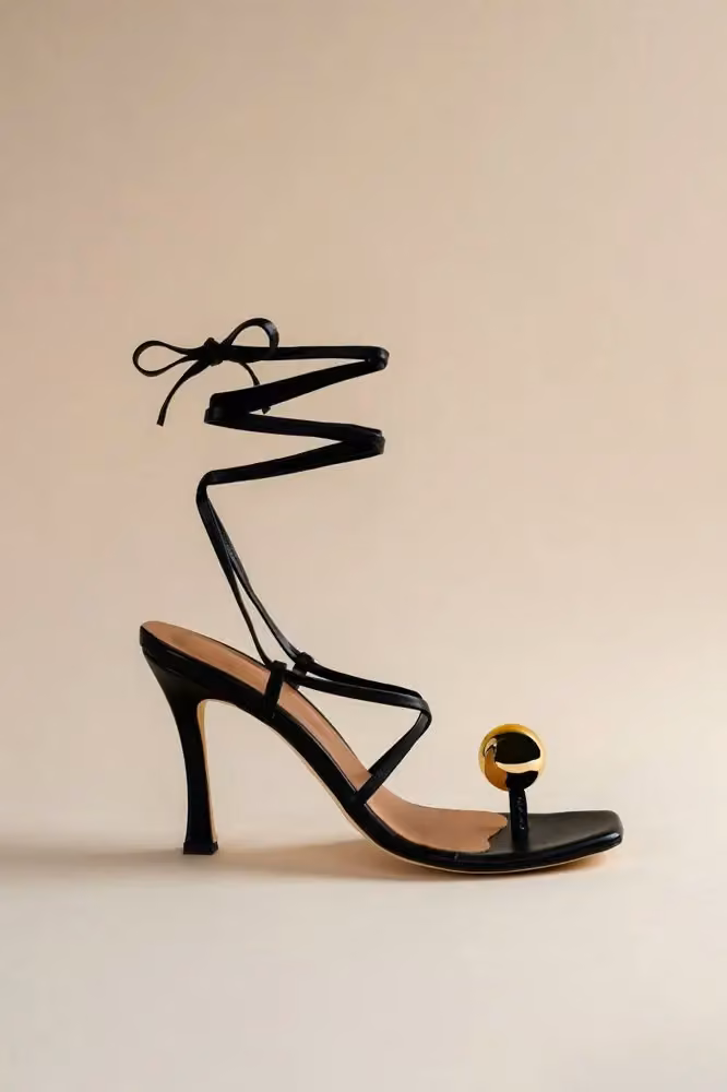 Globe sandal in black nappa leather with a gold sphere heel — Aurora James, Date not documented
