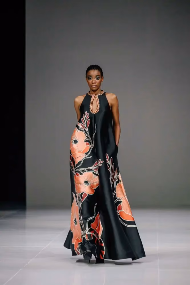 Long dark dress with large floral motifs — Sebastian Gunawan & Cristina Panarese, 2024–2025