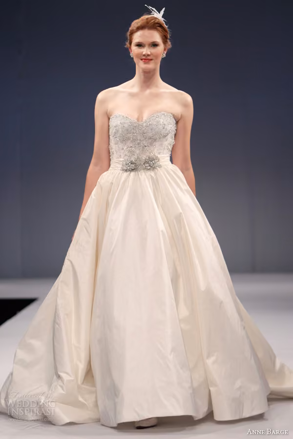 Runway model in the Antoinette strapless ball gown with beaded lace bodice.