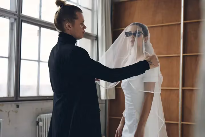White wedding dress with dramatic folded shoulder detail — Soeren Le Schmidt, Date not documented
