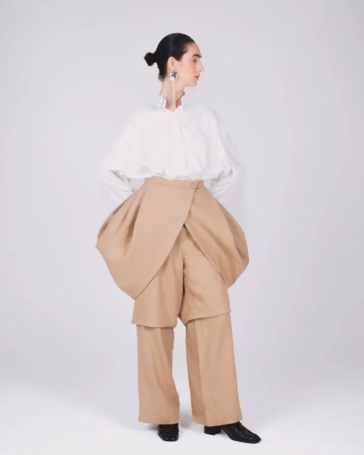 Sculptural beige trousers with a white blouse — Golnar Ahmadian, Date not documented